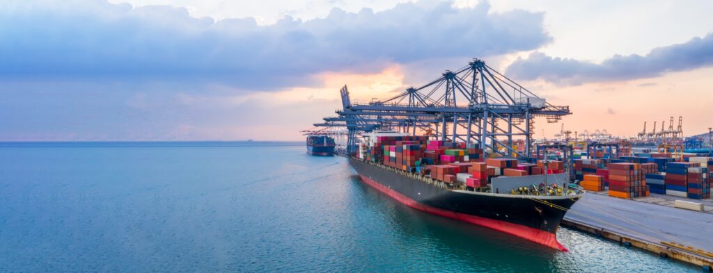 Container ship at a port terminal at sunrise